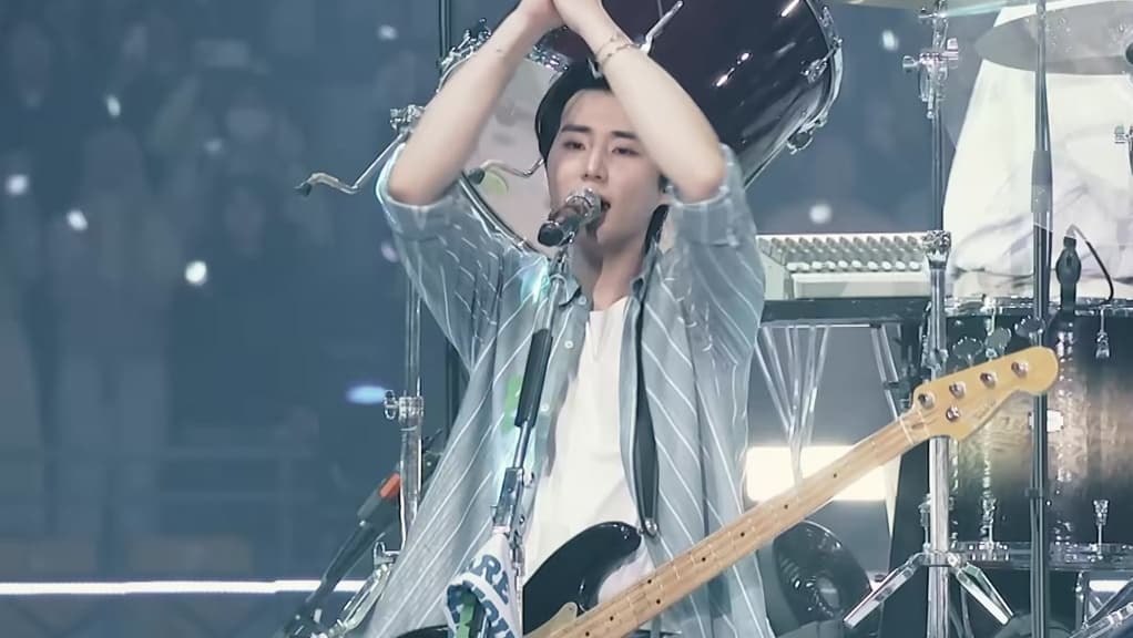 DAY6 guitarist performing live on stage during the Forever Young world tour — YouTube: DAY6