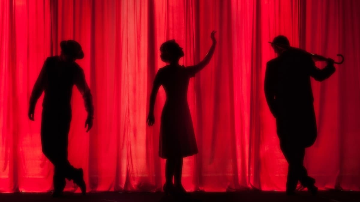 Silhouettes of performers on a theater stage, reflecting the drama class theme of After School Teacher Tae-ri
